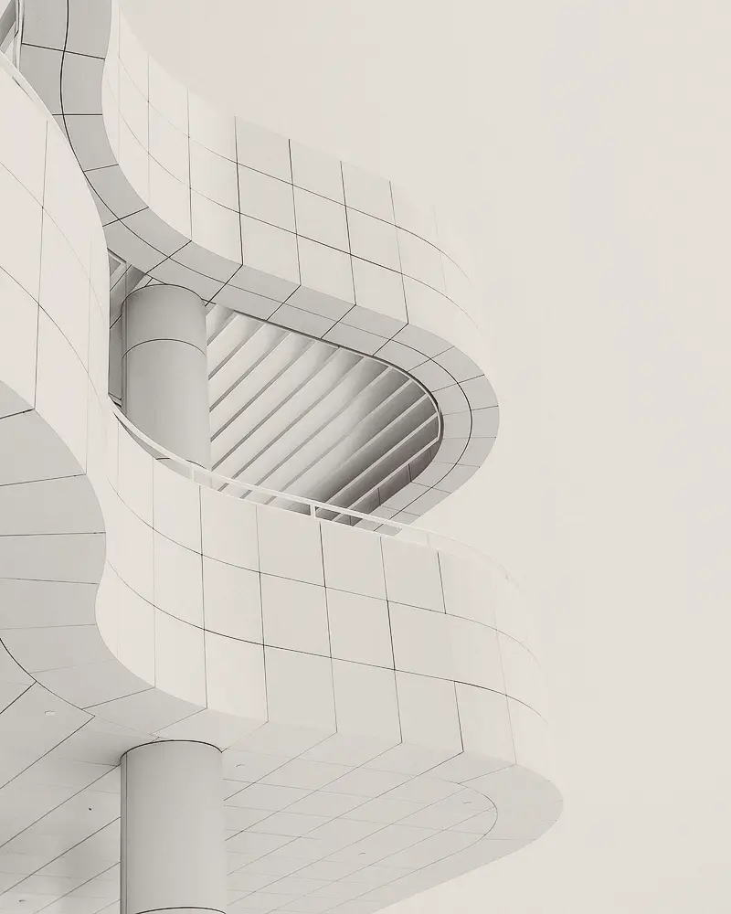 Curving white facade of a modern building.